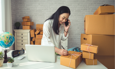 A small business owner working on shipping out a package